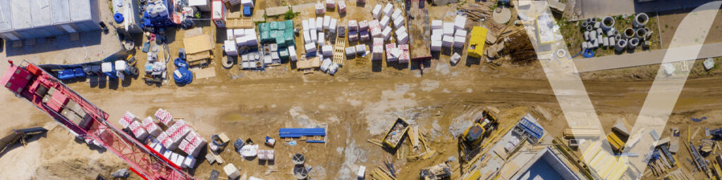 Aerial view of a construction site showcasing procurement of materials and equipment.